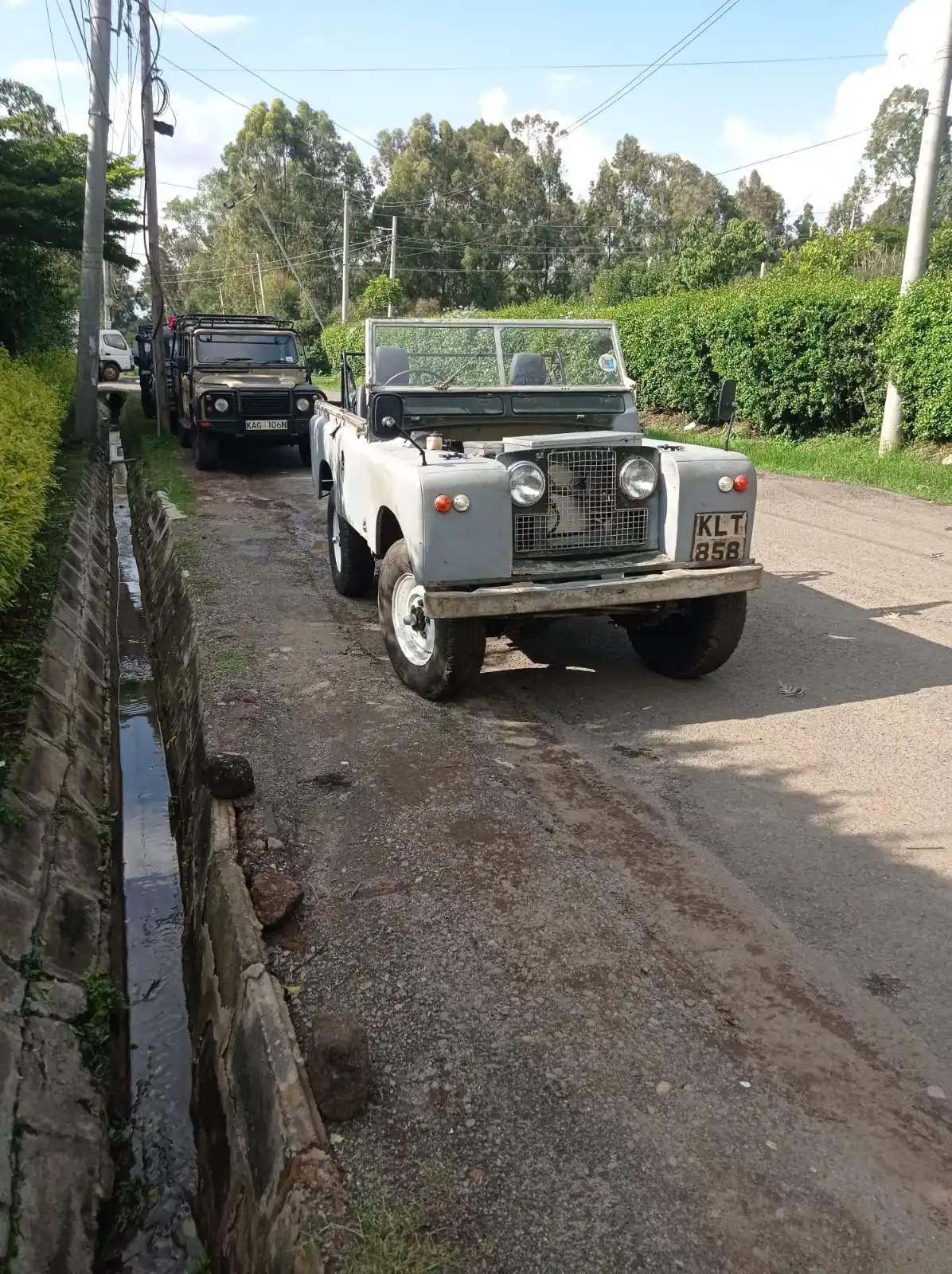 Landrover packed outside a garage